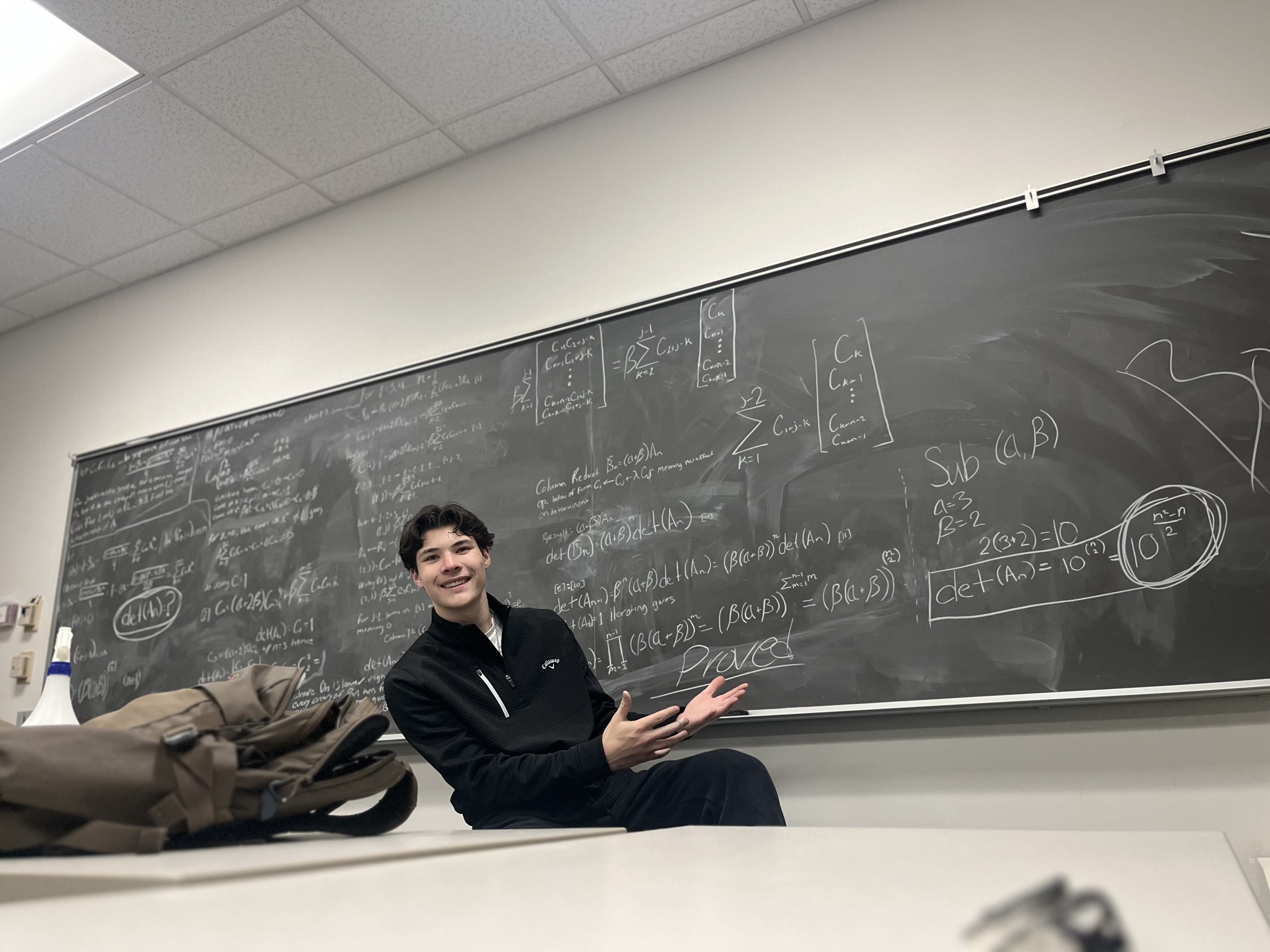 At the chalkboard with math notes